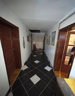 a hallway with a black and white tiled floor at Kuća Petrovic in Niška Banja