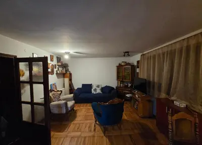 a living room with a blue couch and a blue chair at Kuća Petrovic in Niška Banja