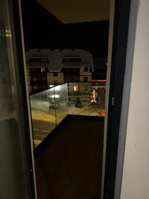 a view from a window of a building at night at DZAT apartman, Harmonija Hotel in Kopaonik