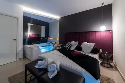 a bedroom with a large bed with towels on it at NAR Royalton Deluxe Apartment #40 Free Parking in Niš
