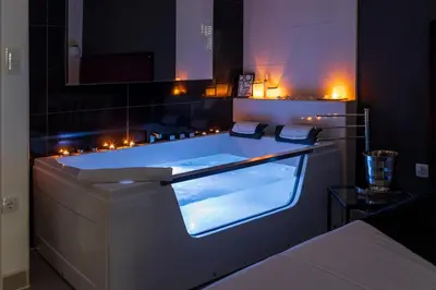 a bath tub in a room with lights at NAR Royalton Deluxe Apartment #40 Free Parking in Niš