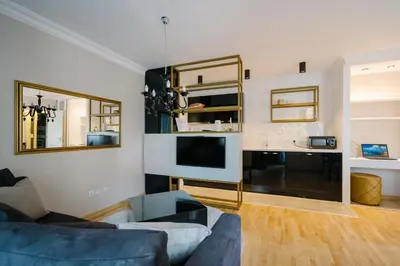 a living room with a couch and a tv at NAR Royalton Deluxe Apartment #63 Free Parking in Niš