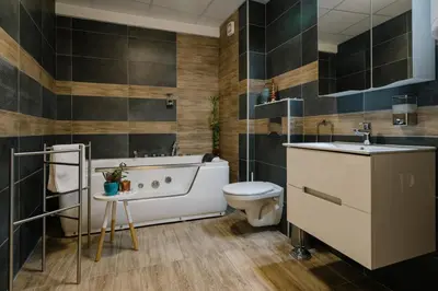 a bathroom with a tub and a toilet and a sink at NAR Royalton Deluxe Apartment #63 Free Parking in Niš