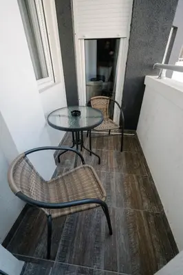 a table and chairs in a room with a window at NAR Royalton Deluxe Apartment #63 Free Parking in Niš