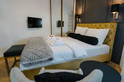 a hotel room with a bed with a baby on it at NAR Royalton Deluxe Apartment #63 Free Parking in Niš