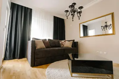 a living room with a couch and a mirror at NAR Royalton Deluxe Apartment #63 Free Parking in Niš