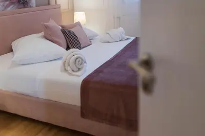 a bedroom with two beds with pillows at NAR Royalton Apartment #71 Free Parking in Niš