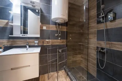 a bathroom with a sink and a shower at NAR Royalton Apartment #71 Free Parking in Niš