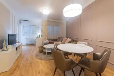 a living room with a table and a couch at NAR Royalton Apartment #71 Free Parking in Niš