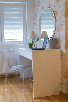 a desk with a mirror and a laptop on it at NAR Royalton Apartment #71 Free Parking in Niš