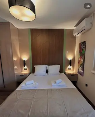 a bedroom with a large bed with two towels on it at Konačište u carstvu in Vrnjci