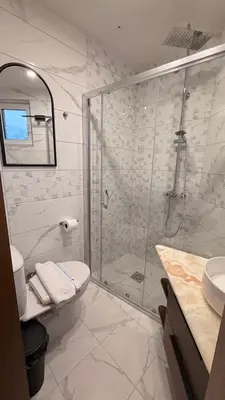 a bathroom with a shower and a toilet and a sink at Konačište u carstvu in Vrnjci