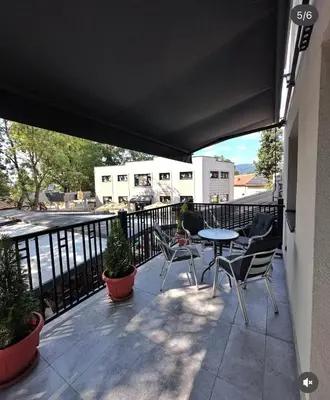 a patio with chairs and a table on a balcony at Konačište u carstvu in Vrnjci