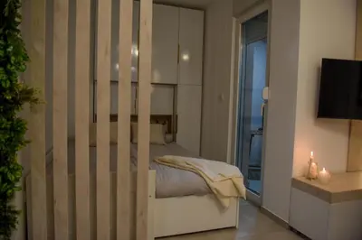 a bedroom with a bed and a television in a room at Apartman P Lux 2 Ćuprija in Ćuprija