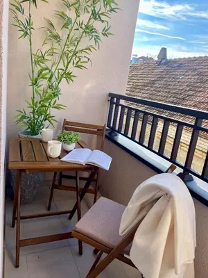 a balcony with a table and a chair and a desk at Apartman P Lux 2 Ćuprija in Ćuprija