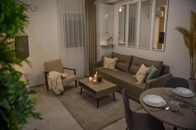 a living room with a couch and a table at Apartman P Lux 2 Ćuprija in Ćuprija