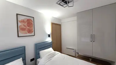 a bedroom with a bed and a cabinet in it at Sunny Hill Kop - Luxury Apartment Mountain View in Kopaonik