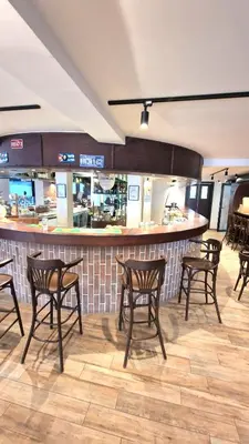 a group of chairs in a restaurant with a bar at Sunny Hill Kop - Luxury Apartment Mountain View in Kopaonik