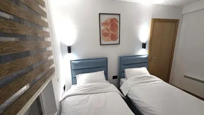two beds in a room next to each other at Sunny Hill Kop - Luxury Apartment Mountain View in Kopaonik