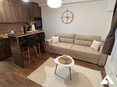a living room with a couch and a table at Apartman Herkul in Kopaonik