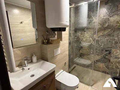 a bathroom with a toilet and a sink and a shower at Apartman Herkul in Kopaonik