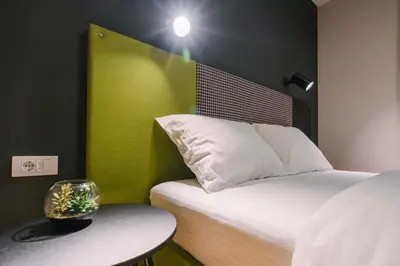 a room with a bed and a table with a table sidx sidx sidx at NAR Royalton Apartment #60 Free Parking in Niš