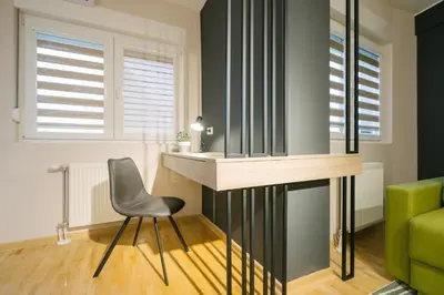 a dining room with a desk and a chair at NAR Royalton Apartment #60 Free Parking in Niš