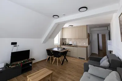 a living room with a couch and a table at Apartman Black Star Kop in Kopaonik