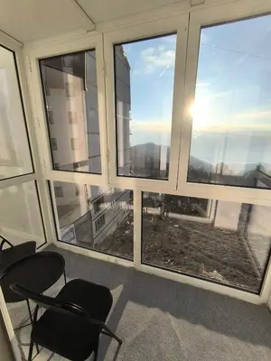 a room with three chairs and windows with the view at Apartman Black Star Kop in Kopaonik