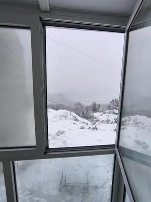 a window with a view of a snow covered field at Apartman Black Star Kop in Kopaonik