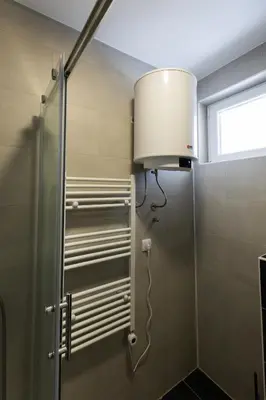 a lamp in a bathroom with a shower at Apartman Black Star Kop in Kopaonik