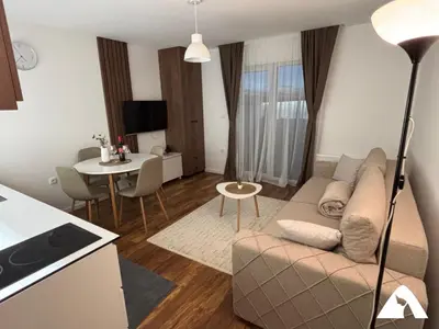 a living room with a couch and a table at Apartman Anči in Kopaonik