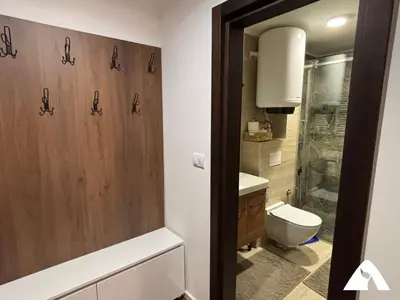 a bathroom with a shower and a toilet and a sink at Apartman Anči in Kopaonik