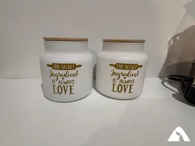 two white candles with the words the self appreciation is always love at Apartman Anči in Kopaonik