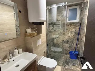 a bathroom with a shower and a toilet and a sink at Apartman Anči in Kopaonik