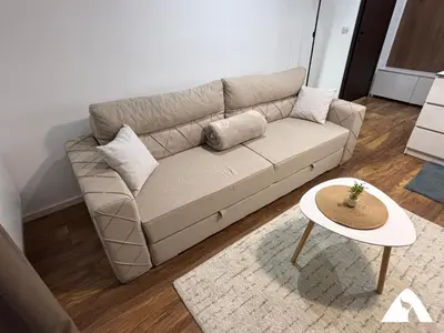 a living room with a couch and a table at Apartman Anči in Kopaonik
