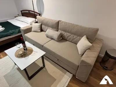 a living room with a couch and a table at Apartman Oliver in Kopaonik