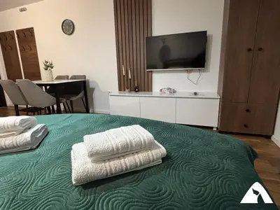 a bedroom with a bed with two towels on it at Apartman Oliver in Kopaonik