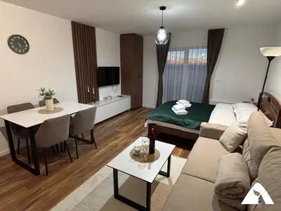 a living room with a couch and a table at Apartman Oliver in Kopaonik