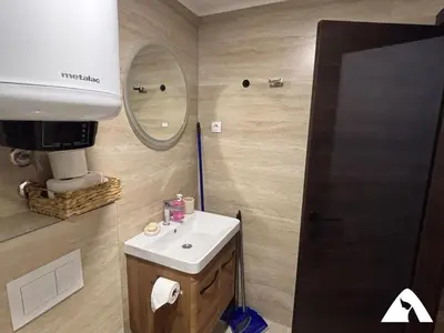 a bathroom with a sink and a mirror at Apartman Oliver in Kopaonik