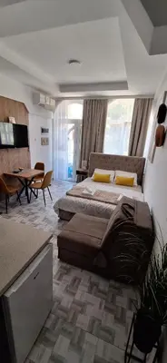 a large bedroom with a large bed and a table at Soko Bajka 2 in Soko Banja