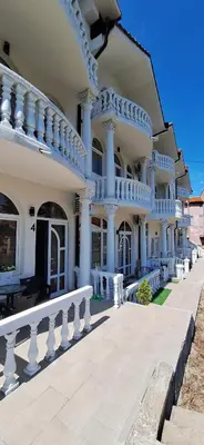 a large building with white columns and a balcony at Soko Bajka 2 in Soko Banja
