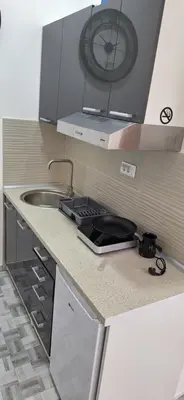 a kitchen with a sink and a clock on the wall at Soko Bajka 2 in Soko Banja