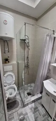 a bathroom with a toilet and a glass shower at Soko Bajka 2 in Soko Banja