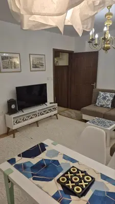 a living room with a couch and a table at City Notes apartment in Niš