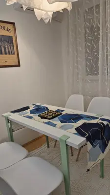 a table with a table cloth on top of it at City Notes apartment in Niš