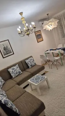 a living room with a couch and a table at City Notes apartment in Niš