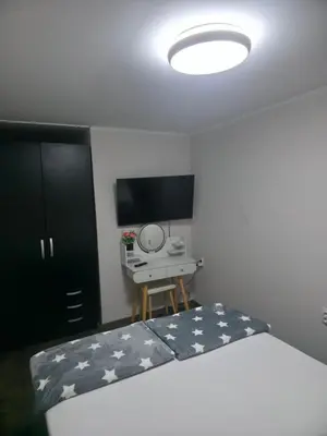 a bedroom with a bed with a desk and a television at Black House Spa