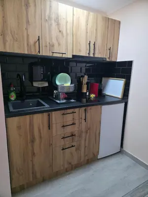 a kitchen with wooden cabinets and a black counter top at Black House Spa