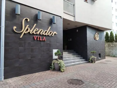 a building with a sign for a hotel at Apartman Besu in Vrnjačka Banja